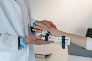 Doctor placing temporary brace on wrist of patient